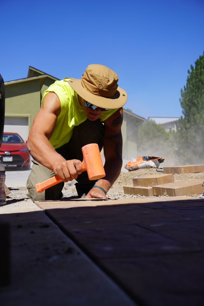 Sam hard at work hammering stone